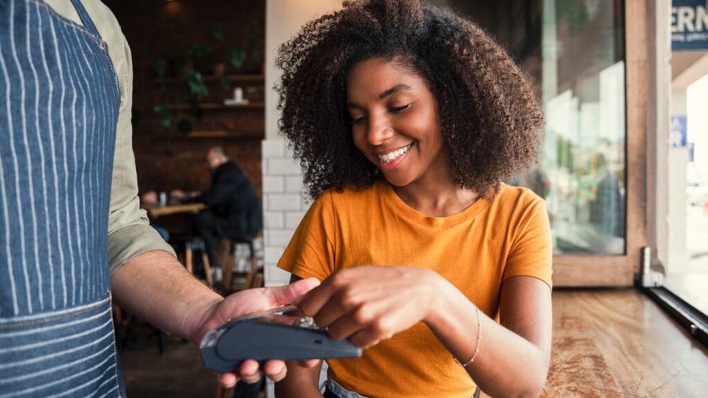 woman paying with credit card in a restaurant