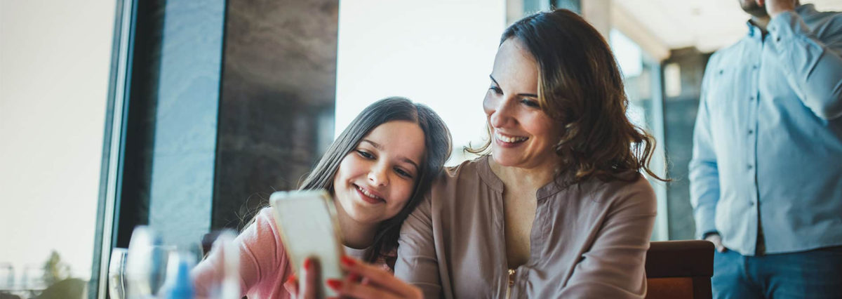 family on phone at table