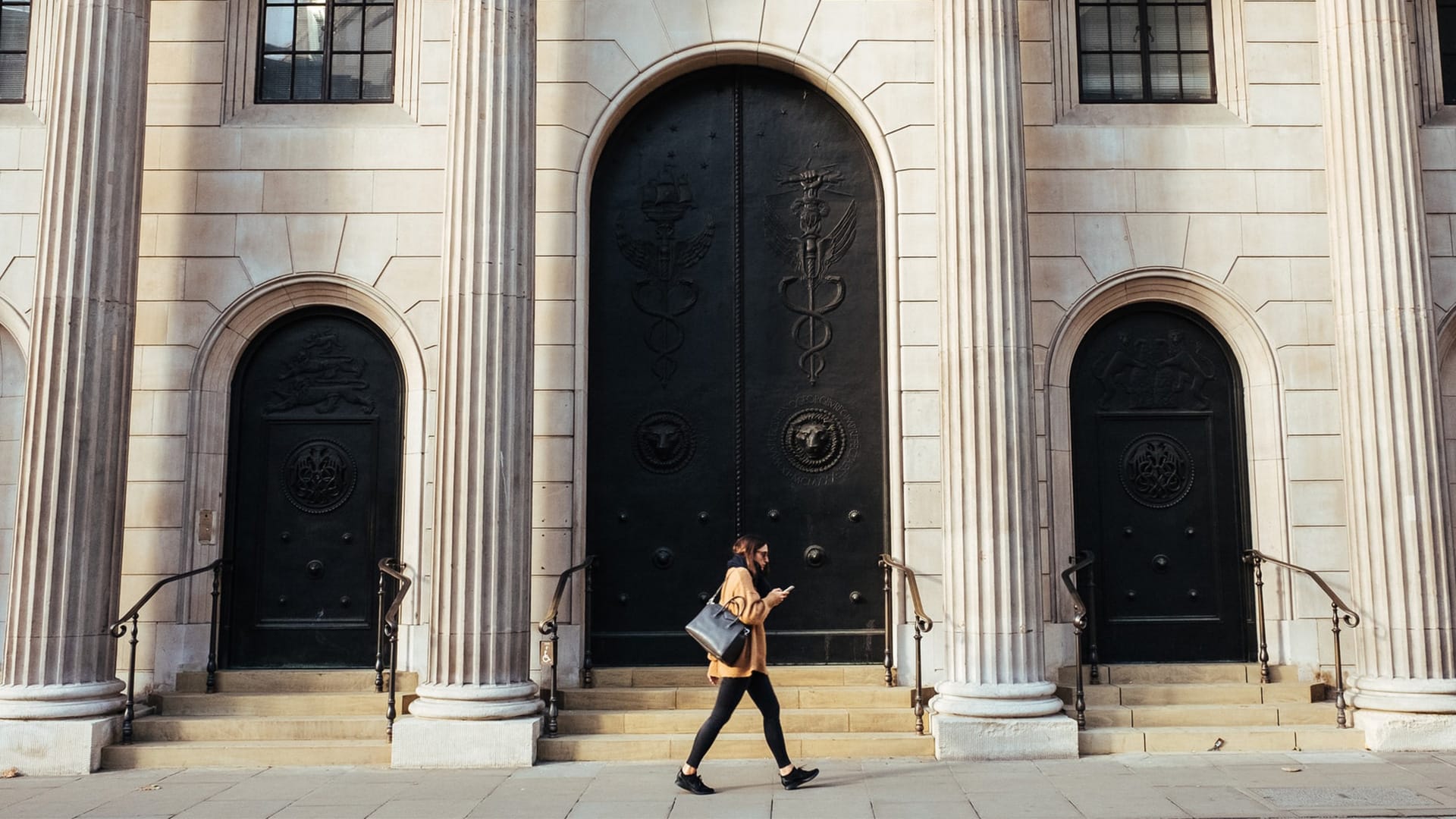 woman walking by bank