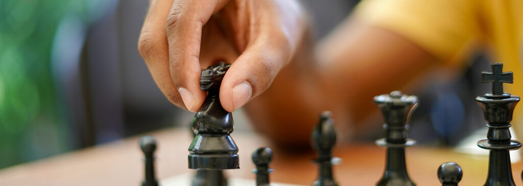 hand on chess pieces