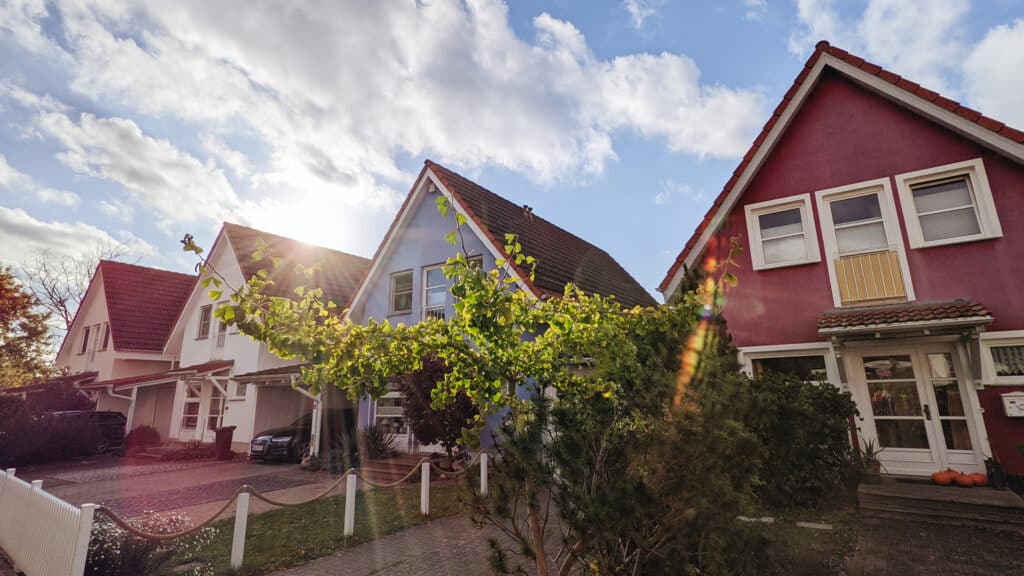 row of houses with blue skies and clouds