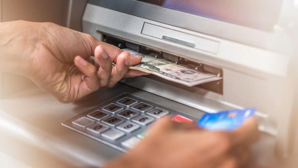 hand getting money from atm