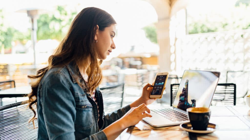 woman checking financials at cafe