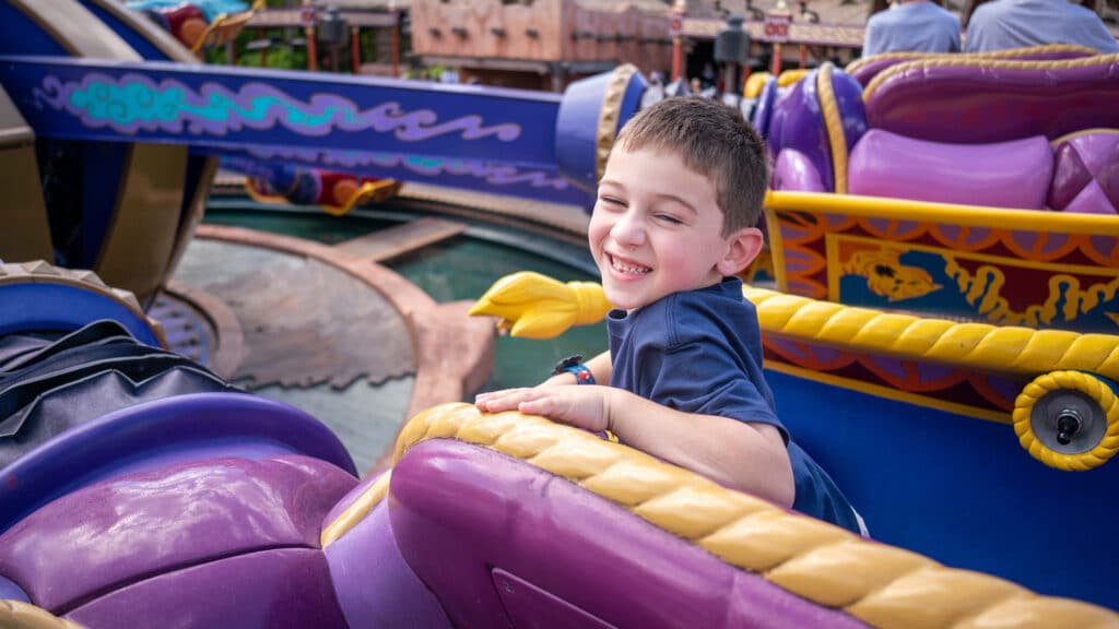 boy on ride at Disney World