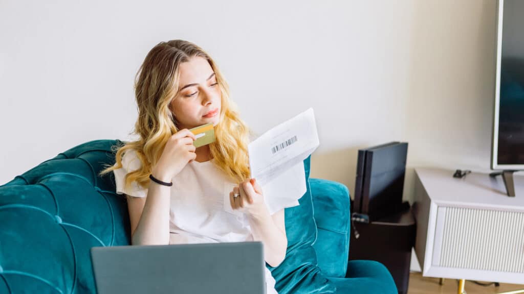 woman reviewing credit card bill at home