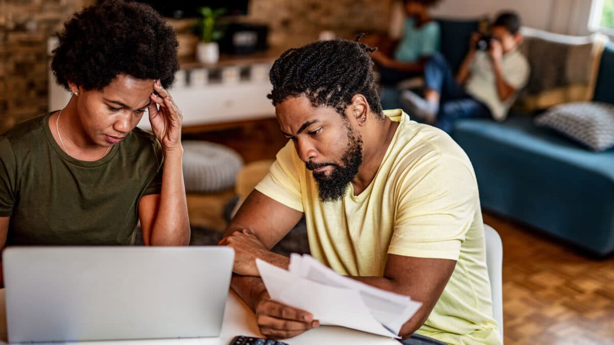 concerned couple looking at finances