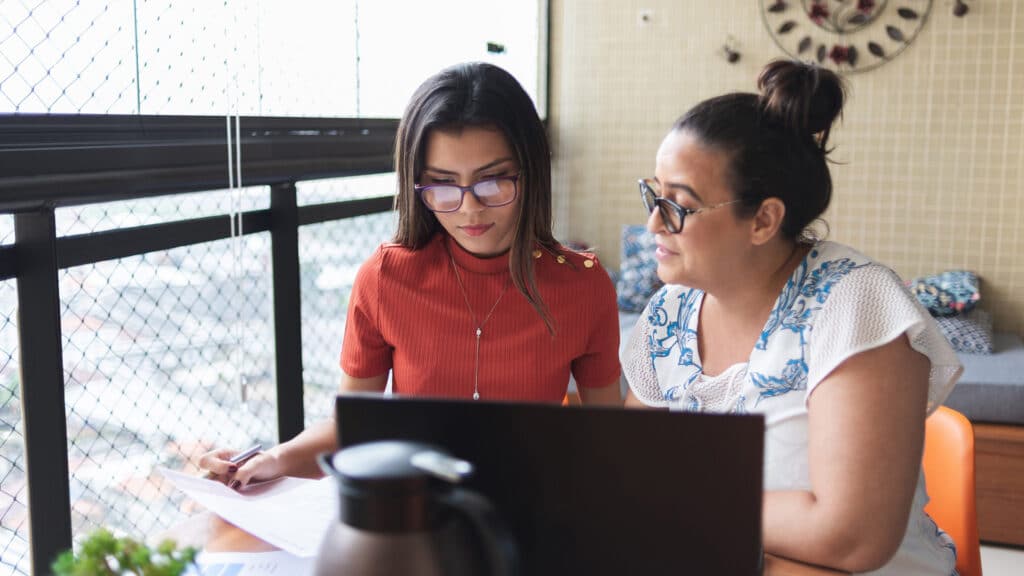 daughter and mother working on finances