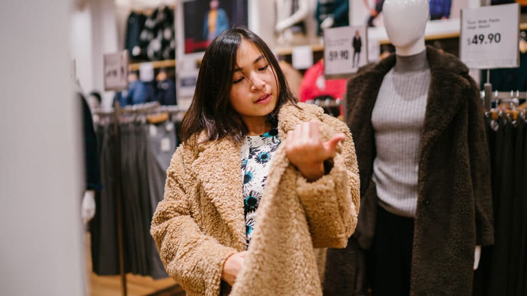 woman shopping for coats