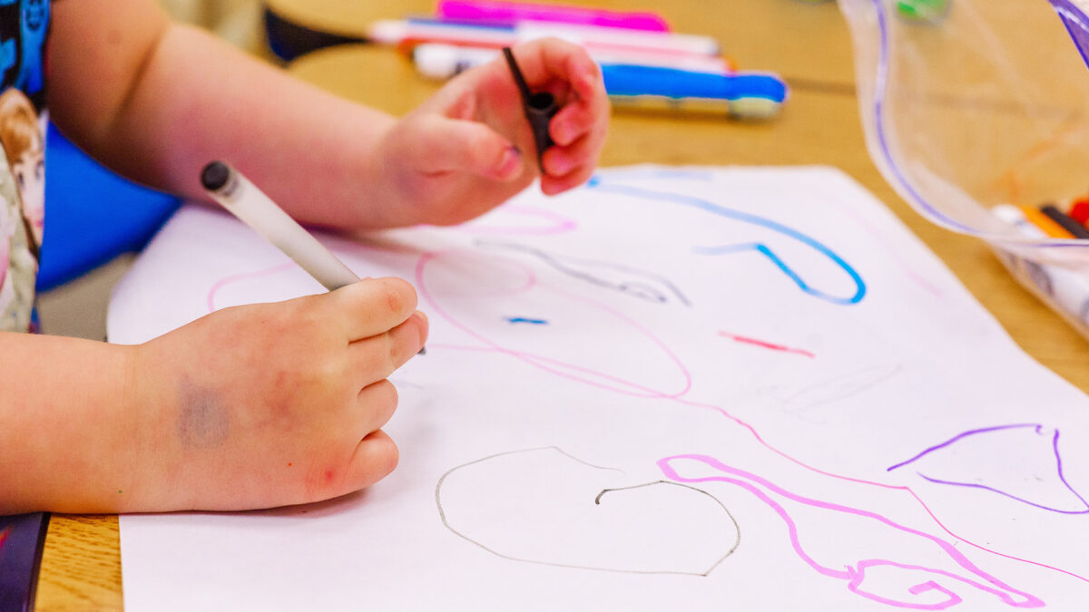 child coloring at daycare