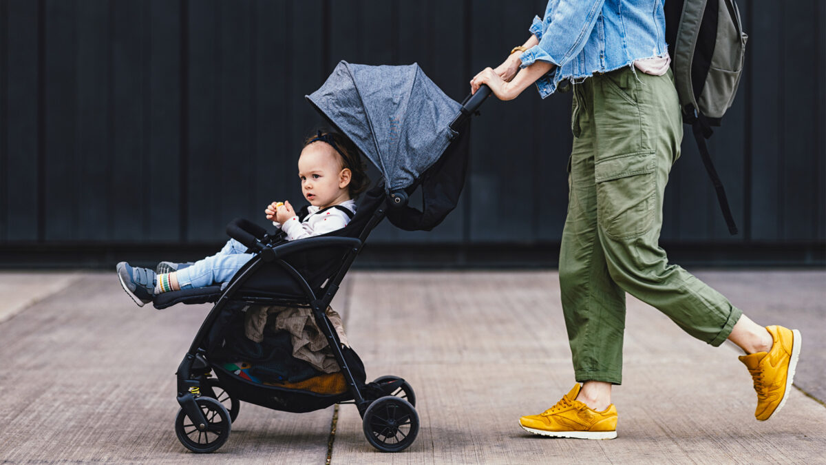 sitter pushing baby in stroller