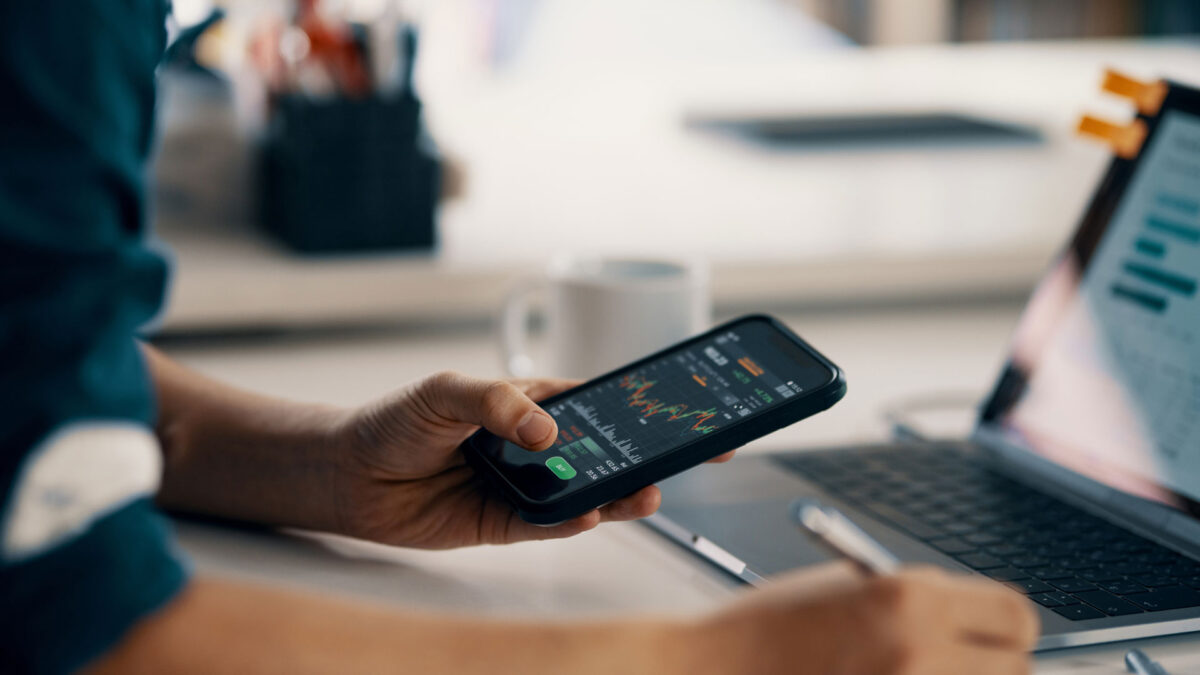 man looking at market on mobile