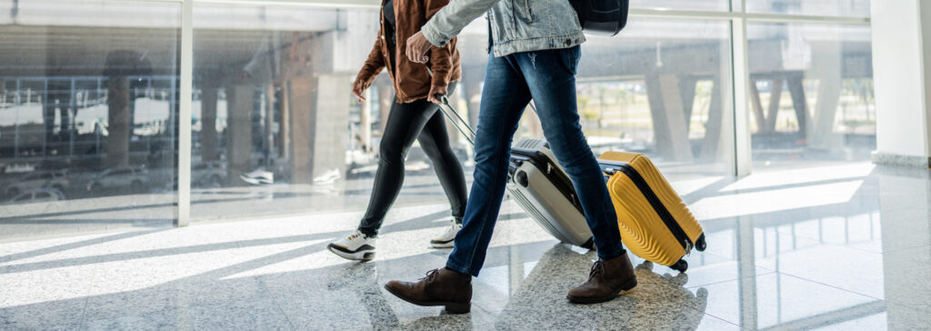 two people walking through the airport